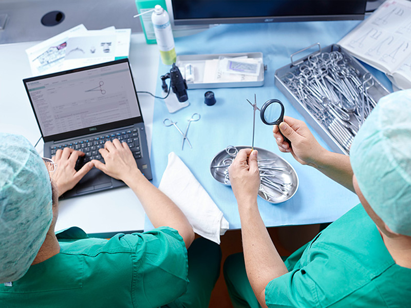 Dva zdravotničtí pracovníci provádějí kvalitativní a kvantitativní kontrolu chirurgických nástrojů.